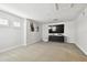 Bright bonus room with large TV, and modern media console at 8766 Shadyside Ln, Land O Lakes, FL 34637