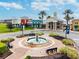 A view of Club Conneton, featuring well-kept landscaping, fountain, and retail and restaurant offerings at 8766 Shadyside Ln, Land O Lakes, FL 34637