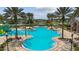 Serene community pool framed by palms and lounge chairs promises leisure and relaxation in a tropical setting at 8766 Shadyside Ln, Land O Lakes, FL 34637