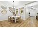 Elegant dining area with modern decor and seamless transition to the staircase and entryway, perfect for gatherings at 8766 Shadyside Ln, Land O Lakes, FL 34637