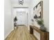 A view of the foyer featuring wood-look floors, decor, and a contemporary light fixture at 8766 Shadyside Ln, Land O Lakes, FL 34637