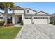 Beautiful two-story home featuring a three-car garage and lovely landscaping at 8766 Shadyside Ln, Land O Lakes, FL 34637