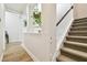 Hallway with stairway and greenery visible through an opening at 8766 Shadyside Ln, Land O Lakes, FL 34637