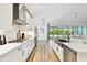 Bright, open kitchen with stainless steel appliances, white cabinets, and large sink overlooking the backyard at 8766 Shadyside Ln, Land O Lakes, FL 34637
