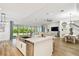 An open kitchen featuring an island with sink, stainless steel appliances, and seamless flow to the living spaces at 8766 Shadyside Ln, Land O Lakes, FL 34637
