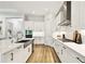 Modern kitchen showcasing stainless steel appliances, white cabinetry, and quartz countertops at 8766 Shadyside Ln, Land O Lakes, FL 34637
