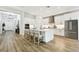 Open kitchen with large island featuring bar stool seating and stainless appliances at 8766 Shadyside Ln, Land O Lakes, FL 34637