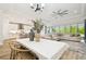 Open-concept living space with an oversized sofa, dining area, and views of the modern kitchen, creating an inviting atmosphere at 8766 Shadyside Ln, Land O Lakes, FL 34637
