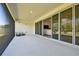 Covered patio with retractable shades and sliding glass doors that open to the interior living area at 8766 Shadyside Ln, Land O Lakes, FL 34637