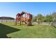Backyard featuring a wooden play set with a slide and swings at 8766 Shadyside Ln, Land O Lakes, FL 34637