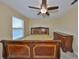 Bedroom featuring a luxurious wood sleigh bed, complemented by a matching dresser and a picturesque window view at 10708 Planer Picket Dr, Riverview, FL 33569