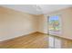 Serene bedroom featuring wood floors and a large arched window with neighborhood views at 11436 2Nd N St # 4, St Petersburg, FL 33716