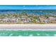 Breathtaking aerial view of a beachfront community with pristine sandy shores and turquoise waters on a sunny day at 119 13Th Ave, Indian Rocks Beach, FL 33785