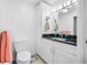 Bathroom featuring granite countertop vanity, storage cabinet, toilet, and stylish lighting at 119 13Th Ave, Indian Rocks Beach, FL 33785