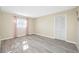 Bright bedroom with wood-look floors, natural light, and a closet provides a serene and inviting atmosphere at 119 13Th Ave, Indian Rocks Beach, FL 33785