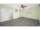 Bedroom featuring wood-look flooring, ceiling fan, closet, and a window for natural light at 119 13Th Ave, Indian Rocks Beach, FL 33785