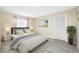 Stylishly furnished bedroom features a cozy bed with modern decor, a window, and closet with wood-look flooring at 119 13Th Ave, Indian Rocks Beach, FL 33785