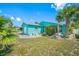Bright and inviting single-story home featuring a well-maintained lawn and mature palm trees at 119 13Th Ave, Indian Rocks Beach, FL 33785
