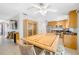 Cozy eat-in kitchen with wooden table, cabinetry, stainless steel appliances, and tile flooring at 119 13Th Ave, Indian Rocks Beach, FL 33785