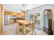 Bright eat-in kitchen with a dining table, wood cabinets, stainless appliances, and access to the patio at 119 13Th Ave, Indian Rocks Beach, FL 33785