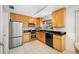 Efficient kitchen with wooden cabinets, stainless steel appliances, and a well-lit workspace at 119 13Th Ave, Indian Rocks Beach, FL 33785