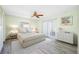 Comfortable main bedroom with wood-look flooring, ceiling fan, and sliding glass doors for backyard access at 119 13Th Ave, Indian Rocks Beach, FL 33785