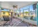 Enclosed porch with tile flooring and ceiling fan, perfect for enjoying the outdoors in comfort at 119 13Th Ave, Indian Rocks Beach, FL 33785