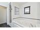 Bathroom boasts a soaking tub, walk-in shower, and vanity area at 1210 Paradise Lake Dr, Tarpon Springs, FL 34689