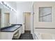 Bright bathroom featuring a vanity, soaking tub, and separate tiled shower at 1210 Paradise Lake Dr, Tarpon Springs, FL 34689