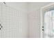 Bright shower with white tile at 1210 Paradise Lake Dr, Tarpon Springs, FL 34689