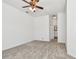 Spacious carpeted bedroom with a ceiling fan and ensuite bathroom at 1210 Paradise Lake Dr, Tarpon Springs, FL 34689