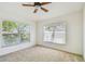 Bright bedroom with neutral carpet and two large windows offering plenty of natural light at 1210 Paradise Lake Dr, Tarpon Springs, FL 34689