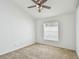 This bedroom boasts neutral carpet and a ceiling fan for added comfort at 1210 Paradise Lake Dr, Tarpon Springs, FL 34689