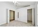 Bright bedroom features a ceiling fan and two closets for ample storage at 1210 Paradise Lake Dr, Tarpon Springs, FL 34689