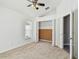 Bright bedroom features a ceiling fan, neutral carpet, and ample closet space at 1210 Paradise Lake Dr, Tarpon Springs, FL 34689