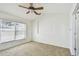 Bedroom featuring neutral carpet, white walls, ceiling fan, and window with blinds, offering a tranquil retreat at 1210 Paradise Lake Dr, Tarpon Springs, FL 34689