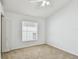 Simple bedroom with carpeted floor, window with blinds, and a ceiling fan at 1210 Paradise Lake Dr, Tarpon Springs, FL 34689