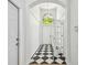 Inviting foyer with black and white checkered tile, soaring ceilings, and arched doorway, creating a grand entrance at 1210 Paradise Lake Dr, Tarpon Springs, FL 34689