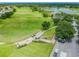 Beautiful aerial view of the golf course with a smooth green fairway and lake at 1210 Paradise Lake Dr, Tarpon Springs, FL 34689