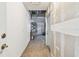 Hallway featuring the entrance, storage, and access to the garage with exposed drywall at 1210 Paradise Lake Dr, Tarpon Springs, FL 34689