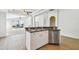 Bright kitchen featuring white cabinets, stainless steel appliances, and an island with a breakfast bar at 1210 Paradise Lake Dr, Tarpon Springs, FL 34689