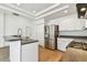 Bright kitchen featuring white cabinets, stainless steel appliances, and an island with a breakfast bar at 1210 Paradise Lake Dr, Tarpon Springs, FL 34689