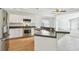 Bright kitchen featuring white cabinets, stainless steel appliances, and an island with a breakfast bar at 1210 Paradise Lake Dr, Tarpon Springs, FL 34689