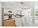 Bright kitchen featuring white cabinets, stainless steel appliances, and an island with a breakfast bar at 1210 Paradise Lake Dr, Tarpon Springs, FL 34689