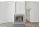 Close-up of a fireplace with gray tile surround, archway to the right leading to another room in the house at 1210 Paradise Lake Dr, Tarpon Springs, FL 34689
