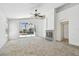 Bright living room featuring a fireplace and sliding glass doors to the outdoor pool area at 1210 Paradise Lake Dr, Tarpon Springs, FL 34689
