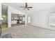 Cozy living room flowing into an open-concept kitchen with stainless steel appliances and breakfast bar at 1210 Paradise Lake Dr, Tarpon Springs, FL 34689