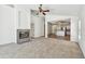 Inviting living room with a fireplace, and an open layout leading to the kitchen and other areas of the home at 1210 Paradise Lake Dr, Tarpon Springs, FL 34689