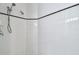 Tiled shower with dual shower heads and classic black-and-white accents at 1210 Paradise Lake Dr, Tarpon Springs, FL 34689