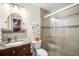 Bathroom featuring granite vanity and glass enclosed shower with decorative tile border at 12204 Sun Vista W Ct, Treasure Island, FL 33706